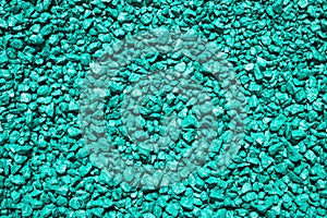 Stones painted in turquoise color. Decorative gravel. Turquoise pebble background texture