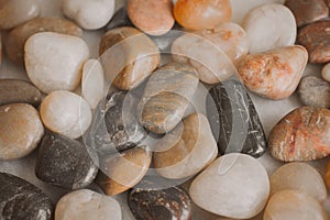 Stones and pebbles as background for design. Close up view of pebbles at the seashore.
