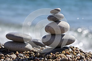 Stones and pebbles stack, harmony and balance, two stone cairns on seacoast