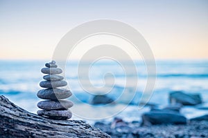 Stones pebbles stacked in a Zen pyramid on sea coast