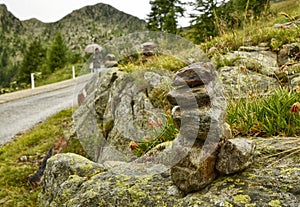 Stones piled up as a Zen memorial along a mountain road