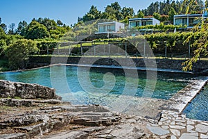 Stones by the pool on the river beach of PoÃ§o de Corga with transparent water, Castanheira de PÃªra PORTUGAL photo
