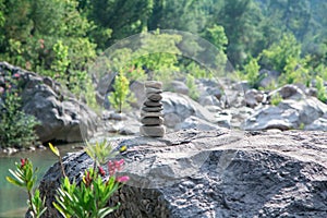 Stones pyramid on rock symbolizing stability, zen, harmony.