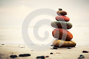 Stones pyramid on sand