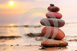 Stones pyramid on sand symbolizing harmony