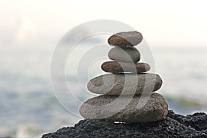 Stones pyramid on sand symbolizing zen