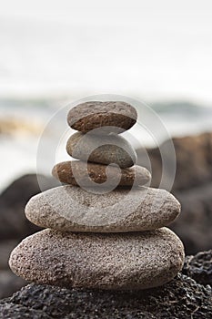 Stones pyramid on sand symbolizing zen, harmony, balance