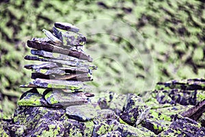 Stones, a pyramid of stones. High mountain landscape, view, texture, wallpaper, background. Drawing. Stones with dried moss.