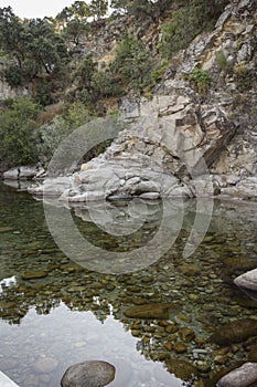 Stones and reflection in the water in the Alardos gorge in Madrigal de la Vera, Caceres, Extremadura, Spain, Europe. photo