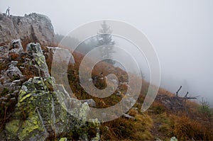 Stones and rocks on blurred background. Foggy autumn mountain landscape