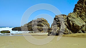 Stones and rocks on sandy beach in Portugal the west Atlantic