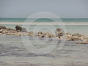 Stones and sand on Fuwairit Beach in Qatar