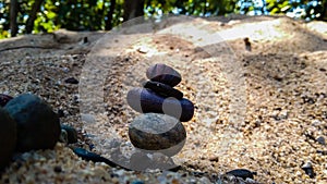 Stones on the sand at noon sun light.