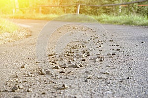 Stones scattered on the asphalt road,