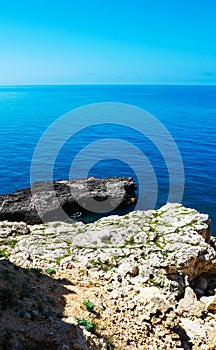 Stones in a sea and blue sky, water background. Bay in Crimea. Black Sea