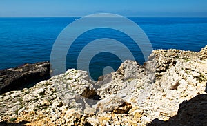 Stones in a sea and blue sky, water background. Bay in Crimea. Black Sea