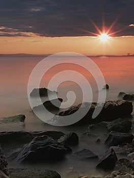 Stones and sea in sunset