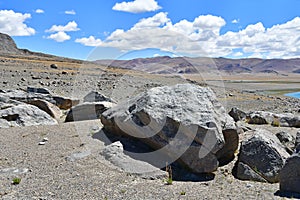 Stones on the shore of lake Tere Tashi Namtso in summer in clear weather