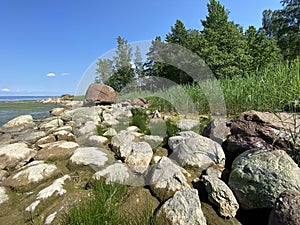 stones on the shore of a reservoir on a summer day