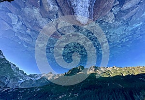 Stones sit at the bottom of Morkie Oko and bask in the Polish sun - POLAND