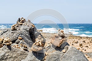 Stones Stacked on Black Volcanic Rock