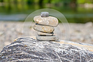 Stones stacked on each other in the background of nature, relaxation and meditat photo