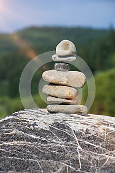 Stones stacked on each other in the background of nature, relaxation and meditat photo