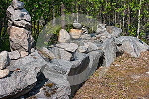 Stones stacked in a pyramid along the road.