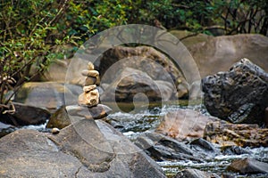 Stones stacked on top of each other at river in Thailand