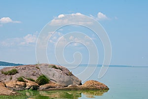 Stones in a stream with smooth running water, idealistic landscape, Sunny day on the river,