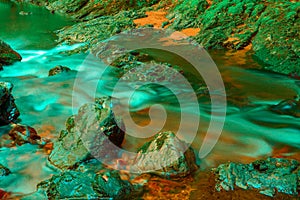 Stones in a stream with water blurred by long exposure