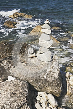 Stones tower on pebble beach with Adriatia Sea in the background