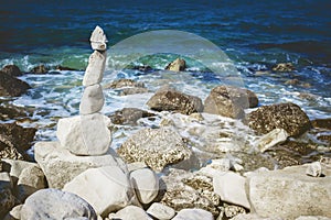 Stones tower on pebble beach with Adriatic Sea in the background