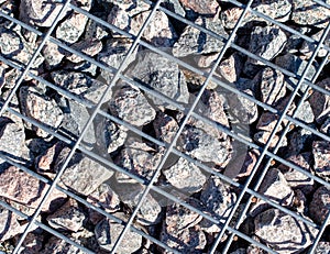 Stones under a metal grate. Background