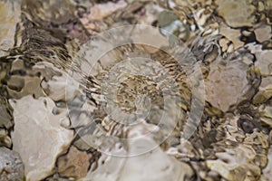 Stones under water. Blurred background