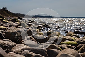 Stones of varying  are on the seashore