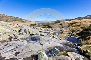 Stones and wild river on hiking trail to the Laguna Grande de Gredos, Spain. photo