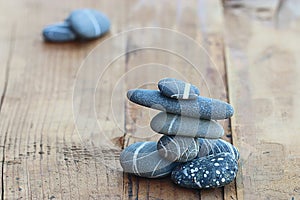 Stones on wooden background balance concept