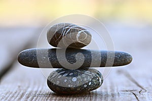 Stones on wooden background balance concept