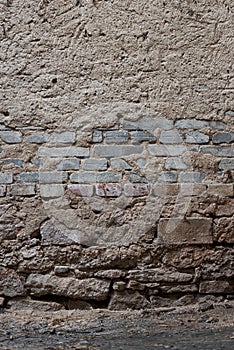 Stonewall in an old barn. Aged brick wall.