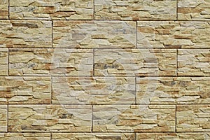 Stoneware cladding wall with stone effect. Colors are flaxen yellow, beige and brown. photo