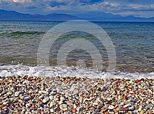 The stoney shores of Nikolaiika Beach on the Corinthian Gulf in Greece