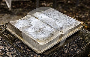 Stony book sculpture on the old gravestone