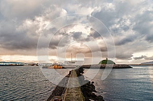 Stony breakwater in sea. Breakwater surround docks, ports and lagoons. Breakwater function concept. Breakwater