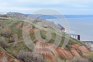 Stony, pebble and clay banks of the Volga River. Mountain slope of various stone rocks. Spring cloudy day with rain. Beautiful