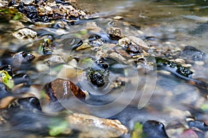 A stony streambed, a stream of clear water