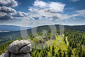 Stony viewpoint in Jizera Mountains under blue cloudy sky