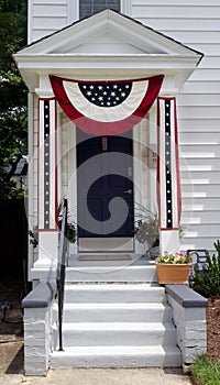 Stoop decorated with patriotic red, white and blue banner accents