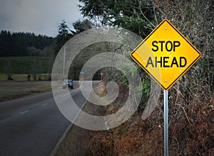 STOP AHEAD road sign on street