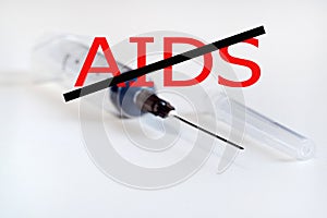 Stop aids. No drugs. Syringe with needle on light background. The needle in the protective cap photo